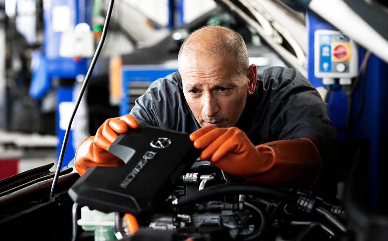 Mazda Master Technician inspecting an engine